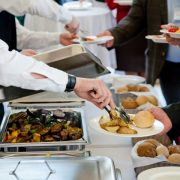 People at the reception taking food on plates